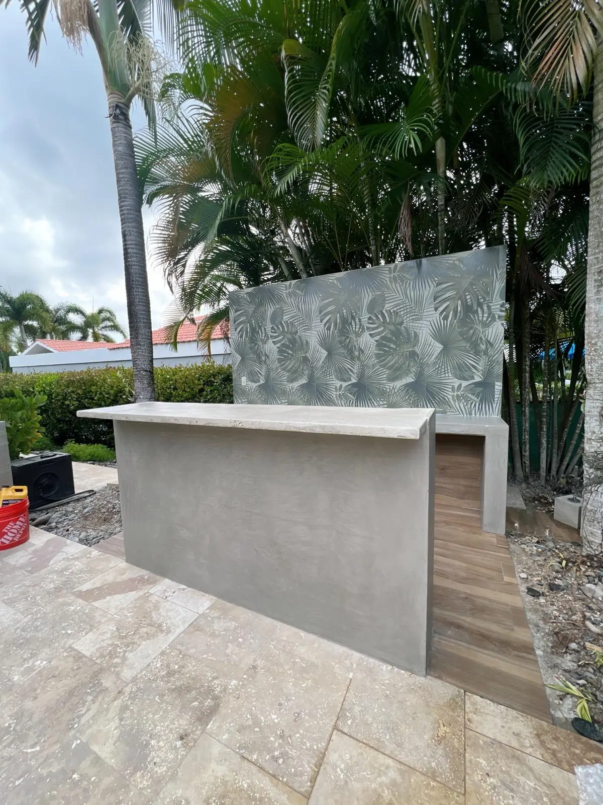 Barra exterior con cemento pulido y pared decorativa tropical
